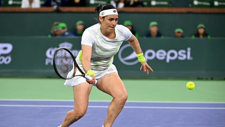 Mar 11, 2023; Indian Wells, CA, USA;  Ons Jabeur (TUN) hits a shot during her second round match against Magdalena Frech (POL) in the BNP Paribas Open at the Indian Wells Tennis Garden. Mandatory Credit: Jayne Kamin-Oncea-USA TODAY Sports