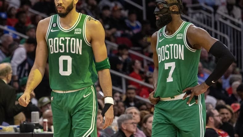 Mar 13, 2023; Houston, Texas, USA; Boston Celtics forward Jayson Tatum (0) and guard Jaylen Brown (7) talk to each other during a Houston Rockets timeout in the second quarter at Toyota Center. Mandatory Credit: Thomas Shea-USA TODAY Sports