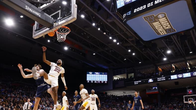 Mar 15, 2023; Dayton, OH, USA; Arizona State Sun Devils forward Warren Washington (22) steal the ball away from Nevada Wolf Pack center Will Baker (50) in the first half at UD Arena. Mandatory Credit: Rick Osentoski-USA TODAY Sports