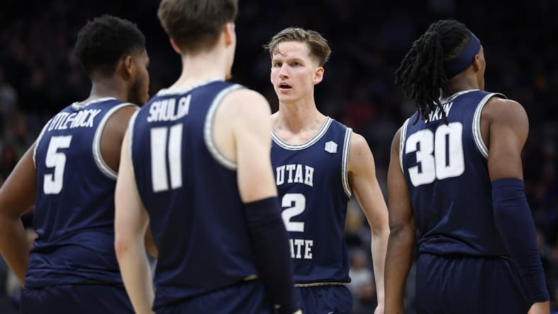 Mar 16, 2023; Sacramento, CA, USA; Utah State Aggies guard Sean Bairstow (2) speaks with guard Max Shulga (11) and guard RJ Eytle-Rock (5) during the first half at Golden 1 Center. Mandatory Credit: Kelley L Cox-USA TODAY Sports