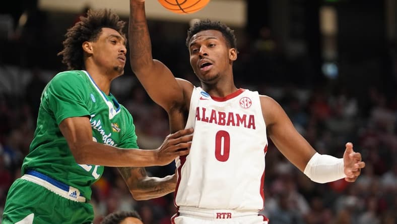 Mar 16, 2023; Birmingham, AL, USA; Alabama Crimson Tide guard Jaden Bradley (0) passes the ball away from Texas A&M-CC Islanders guard Simeon Fryer (22) during the second half in the first round of the 2023 NCAA Tournament at Legacy Arena. Mandatory Credit: Marvin Gentry-USA TODAY Sports