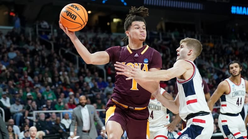 Mar 17, 2023; Albany, NY, USA; Iona Gaels guard Walter Clayton Jr. (1) passes the ball against UConn Huskies guard Joey Calcaterra (3) during the first half at MVP Arena. Mandatory Credit: David Butler II-USA TODAY Sports