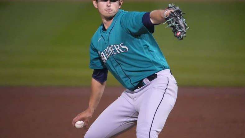 Mar 17, 2023; Peoria, Arizona, USA; Seattle Mariners starting pitcher Chris Flexen (77) pitches against the San Diego Padres during the first inning at Peoria Sports Complex. Mandatory Credit: Joe Camporeale-USA TODAY Sports
