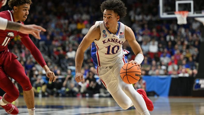 Mar 18, 2023; Des Moines, IA, USA; Kansas Jayhawks forward Jalen Wilson (10) drives against Arkansas Razorbacks forward Jalen Graham (11) during the first half at Wells Fargo Arena. Mandatory Credit: Jeffrey Becker-USA TODAY Sports