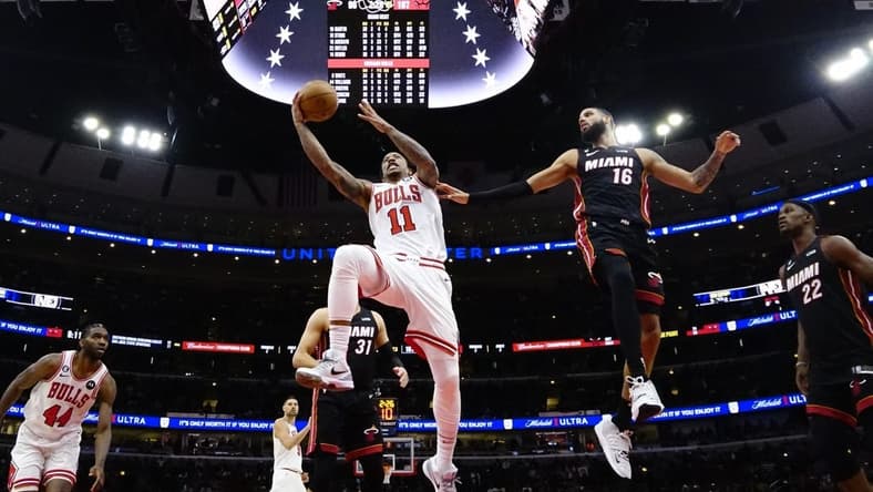 Mar 18, 2023; Chicago, Illinois, USA; Miami Heat forward Caleb Martin (16) defends Chicago Bulls forward DeMar DeRozan (11) during the second half at United Center. Mandatory Credit: David Banks-USA TODAY Sports