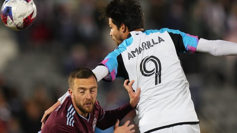 Mar 18, 2023; Commerce City, Colorado, USA; Colorado Rapids defender Danny Wilson (4) fights for the ball against Minnesota United forward Luis Amarilla (9) at Dick's Sporting Goods Park. Mandatory Credit: Ron Chenoy-USA TODAY Sports