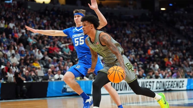 Mar 19, 2023; Denver, CO, USA; Baylor Bears forward Jalen Bridges (11) drives against Creighton Bluejays guard Baylor Scheierman (55) in the first half at Ball Arena. Mandatory Credit: Ron Chenoy-USA TODAY Sports
