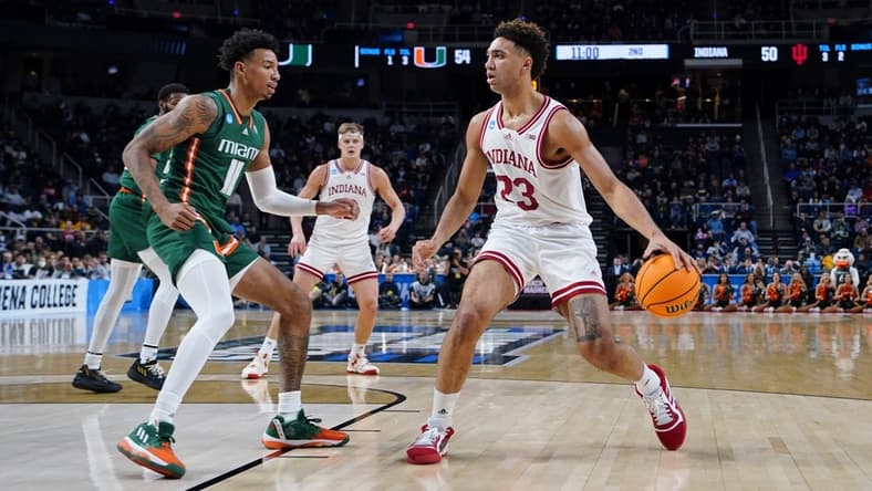 Mar 19, 2023; Albany, NY, USA; Indiana Hoosiers forward Trayce Jackson-Davis (23) dribbles the ball against Miami (Fl) Hurricanes guard Jordan Miller (11) during the second half at MVP Arena. Mandatory Credit: Gregory Fisher-USA TODAY Sports