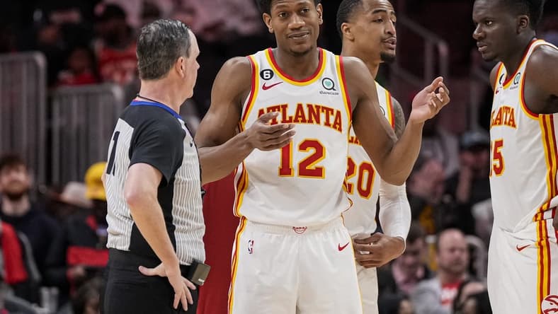 Mar 21, 2023; Atlanta, Georgia, USA; Atlanta Hawks forward De'Andre Hunter (12) discusses a call with the official during the game against the Detroit Pistons during the second half at State Farm Arena. Mandatory Credit: Dale Zanine-USA TODAY Sports