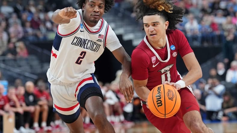 Mar 23, 2023; Las Vegas, NV, USA; Arkansas Razorbacks guard Anthony Black (0) dribbles the ball against UConn Huskies guard Tristen Newton (2) during the first half at T-Mobile Arena. Mandatory Credit: Joe Camporeale-USA TODAY Sports
