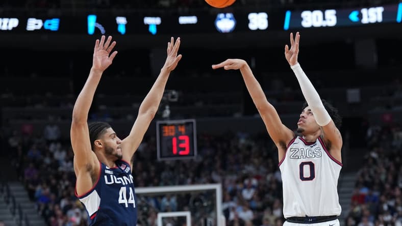 Mar 25, 2023; Las Vegas, NV, USA; Gonzaga Bulldogs guard Julian Strawther (0) shoots the ball against Connecticut Huskies guard Andre Jackson Jr. (44) during the first half for the NCAA tournament West Regional final at T-Mobile Arena. Mandatory Credit: Joe Camporeale-USA TODAY Sports