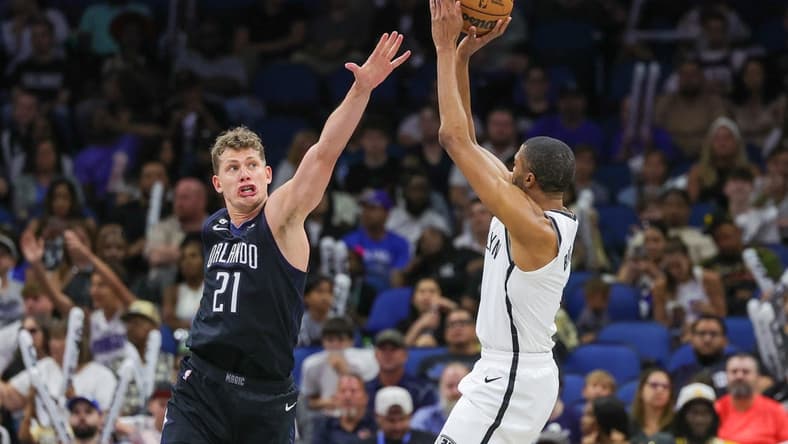 Mar 26, 2023; Orlando, Florida, USA; Brooklyn Nets forward Mikal Bridges (1) shoots the ball against Orlando Magic center Moritz Wagner (21) during the second half at Amway Center. Mandatory Credit: Mike Watters-USA TODAY Sports