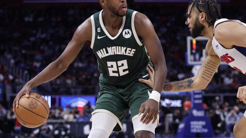 Mar 27, 2023; Detroit, Michigan, USA;  Milwaukee Bucks forward Khris Middleton (22) dribbles defended by Detroit Pistons forward Isaiah Livers (12) in the second half at Little Caesars Arena. Mandatory Credit: Rick Osentoski-USA TODAY Sports