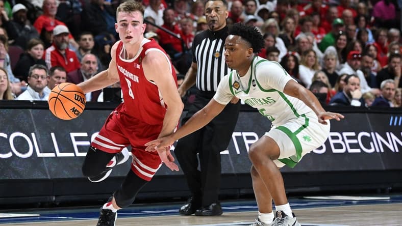 Mar 28, 2023; Las Vegas, NV, USA; Wisconsin Badgers forward Tyler Wahl (5) dribbles past North Texas Mean Green guard Tylor Perry (5) during the first half at Orleans Arena. Mandatory Credit: Candice Ward-USA TODAY Sports