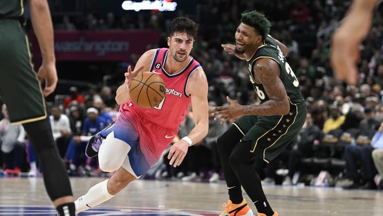 Mar 28, 2023; Washington, District of Columbia, USA; Washington Wizards forward Deni Avdija (9) dribbles past Boston Celtics guard Marcus Smart (36) during the second half at Capital One Arena. Mandatory Credit: Brad Mills-USA TODAY Sports
