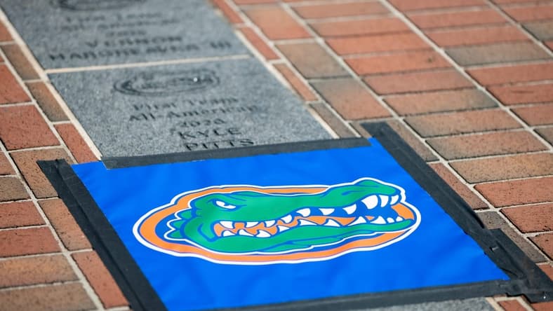 A Florida Gators logo protecting the spot where Florida Gators offensive lineman O'Cyrus Torrence (54) All-American brick will be installed outside Ben Hill Griffin Stadium in Gainesville, FL on Wednesday, March 29, 2023. [Matt Pendleton/Gainesville Sun]

Ncaa Football O Cyrus Torrence All American Brick Dedication