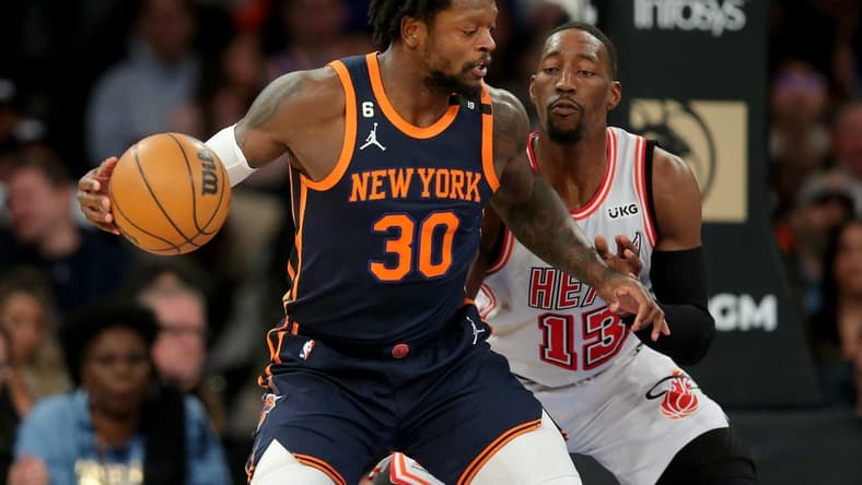 Mar 29, 2023; New York, New York, USA; New York Knicks forward Julius Randle (30) controls the ball against Miami Heat center Bam Adebayo (13) during the first quarter at Madison Square Garden. Mandatory Credit: Brad Penner-USA TODAY Sports