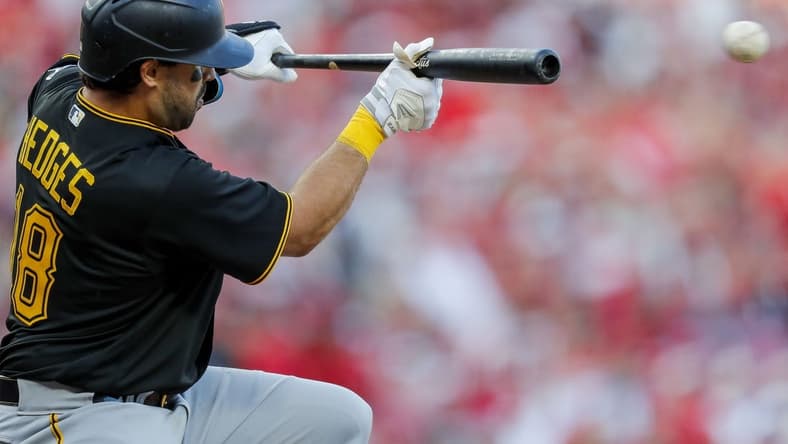 Mar 30, 2023; Cincinnati, Ohio, USA; Pittsburgh Pirates catcher Austin Hedges (18) bunts against the Cincinnati Reds in the eighth inning at Great American Ball Park. Mandatory Credit: Katie Stratman-USA TODAY Sports