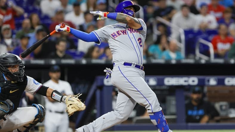 Mar 30, 2023; Miami, Florida, USA; New York Mets catcher Omar Narvaez (2) hits a single during the third inning against the Miami Marlins at loanDepot Park. Mandatory Credit: Sam Navarro-USA TODAY Sports