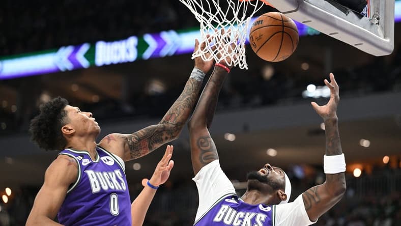 Mar 30, 2023; Milwaukee, Wisconsin, USA; Milwaukee Bucks guard MarJon Beauchamp (0) and Milwaukee Bucks forward Bobby Portis (9) battle for a rebound in the second half at Fiserv Forum. Mandatory Credit: Michael McLoone-USA TODAY Sports