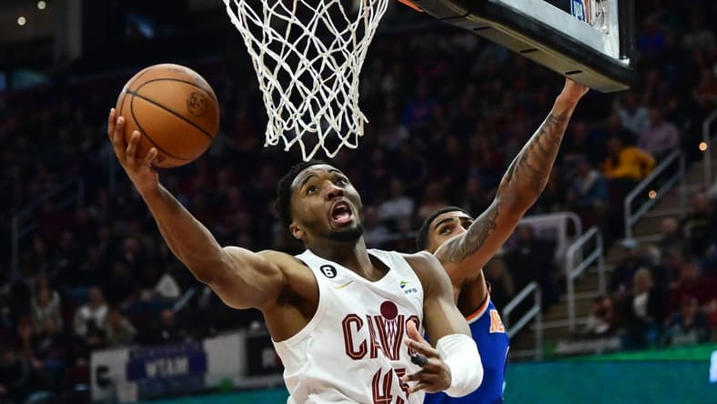 Mar 31, 2023; Cleveland, Ohio, USA; Cleveland Cavaliers guard Donovan Mitchell (45) drives to the basket against New York Knicks forward Obi Toppin (1) during the second half at Rocket Mortgage FieldHouse. Mandatory Credit: Ken Blaze-USA TODAY Sports
