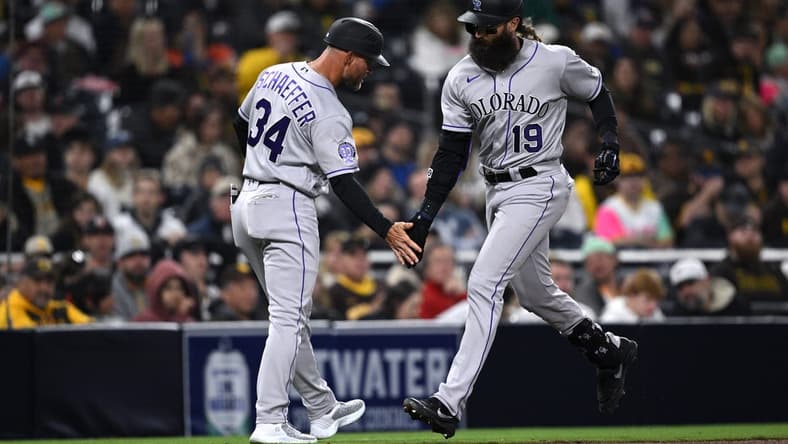 Mar 31, 2023; San Diego, California, USA; Colorado Rockies designated hitter Charlie Blackmon (19) is congratulated by third base coach Warren Schaeffer (34) after hitting a two-run home run during the fifth inning against the San Diego Padresat Petco Park. Mandatory Credit: Orlando Ramirez-USA TODAY Sports