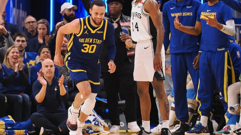 Mar 31, 2023; San Francisco, California, USA; Golden State Warriors guard Stephen Curry (30) smiles as he returns to defense after scoring a three point basket against the San Antonio Spurs during the second quarter at Chase Center. Mandatory Credit: Kelley L Cox-USA TODAY Sports