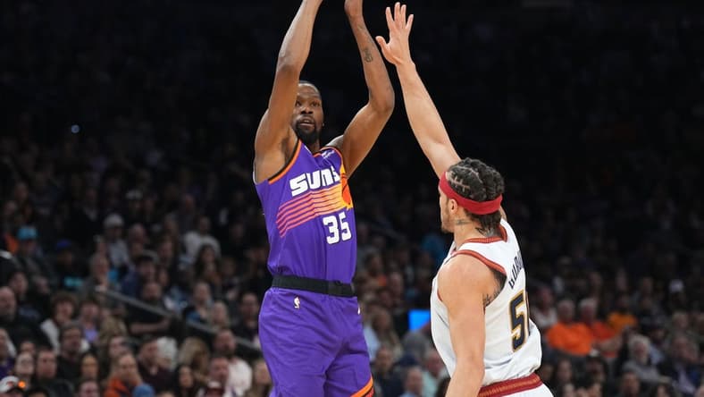 Mar 31, 2023; Phoenix, Arizona, USA; Phoenix Suns forward Kevin Durant (35) shoots over Denver Nuggets forward Aaron Gordon (50) during the first half at Footprint Center. Mandatory Credit: Joe Camporeale-USA TODAY Sports