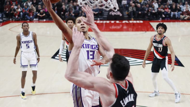 Mar 31, 2023; Portland, Oregon, USA; Sacramento Kings small forward Keegan Murray (13) shoots the ball as Portland Trail Blazers power forward Drew Eubanks (24)  defends during the first half at Moda Center. Mandatory Credit: Soobum Im-USA TODAY Sports