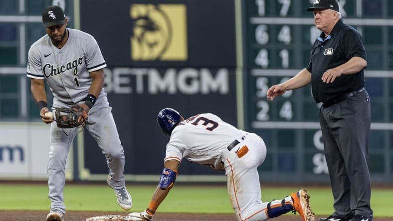 Apr 1, 2023; Houston, Texas, USA; Houston Astros shortstop Jeremy Pena (3) is safe with a RBI double against Chicago White Sox second baseman Elvis Andrus (1) in the fourth inning at Minute Maid Park. Mandatory Credit: Thomas Shea-USA TODAY Sports