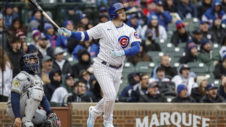 Apr 1, 2023; Chicago, Illinois, USA; Chicago Cubs left fielder Ian Happ (8) hits a solo home run against the Milwaukee Brewers during the sixth inning at Wrigley Field. Mandatory Credit: Kamil Krzaczynski-USA TODAY Sports
