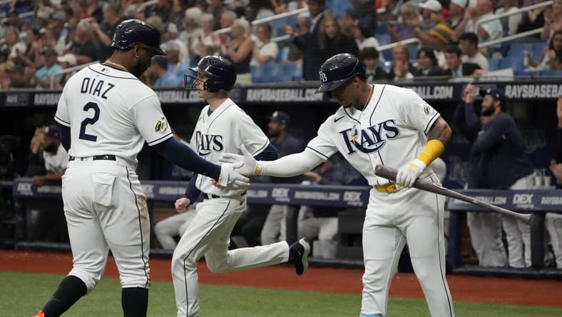 Apr 1, 2023; St. Petersburg, Florida, USA; Tampa Bay Rays first baseman Yandy Diaz (2) is congratulated by shortstop Wander Franco (5) after scoring off of a double by left fielder Randy Arozarena (not pictured) during the first inning at Tropicana Field. Mandatory Credit: Dave Nelson-USA TODAY Sports