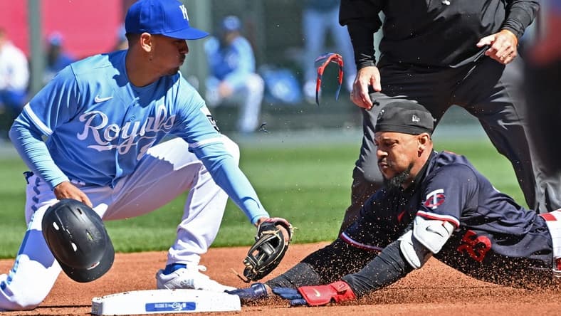 Apr 1, 2023; Kansas City, Missouri, USA; Minnesota Twins designated hitter Byron Buxton (25) dives into second base with a double during the first inning against Kansas City Royals second baseman Nicky Lopez (8) at Kauffman Stadium. Mandatory Credit: Peter Aiken-USA TODAY Sports