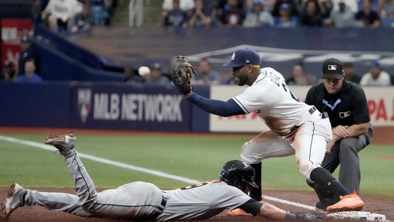 Apr 1, 2023; St. Petersburg, Florida, USA; Detroit Tigers third baseman Nick Maton (9) dives back to first as Tampa Bay Rays first baseman Yandy Diaz (2) tries unsuccessfully to make the tag during the third inning at Tropicana Field. Mandatory Credit: Dave Nelson-USA TODAY Sports