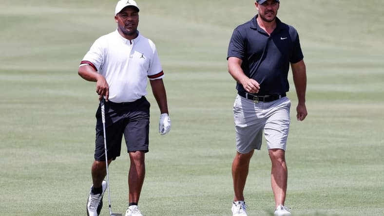 Apr 1, 2023; Orlando, Florida, USA; Harold Varner III of the RangeGoats (left) and Brooks Koepka of the Smash golf club walk onto the fourth green during the second round of a LIV Golf event at Orange County National. Mandatory Credit: Reinhold Matay-USA TODAY Sports