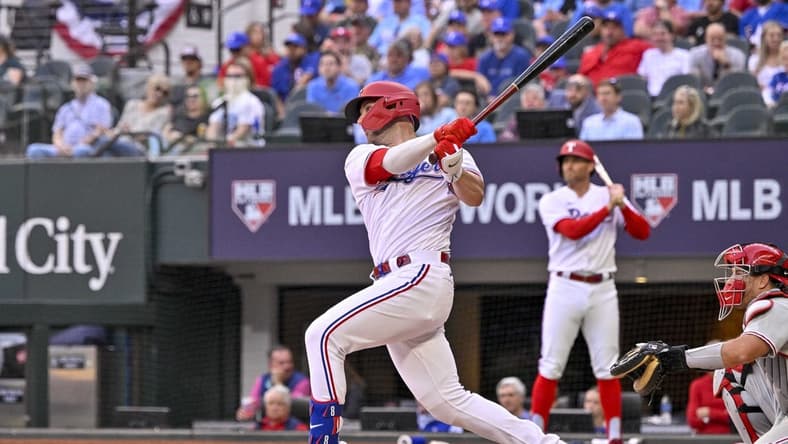 Apr 1, 2023; Arlington, Texas, USA; Texas Rangers catcher Mitch Garver (18) hits a three run home run against the Philadelphia Phillies during the fifth inning at Globe Life Field. Mandatory Credit: Jerome Miron-USA TODAY Sports
