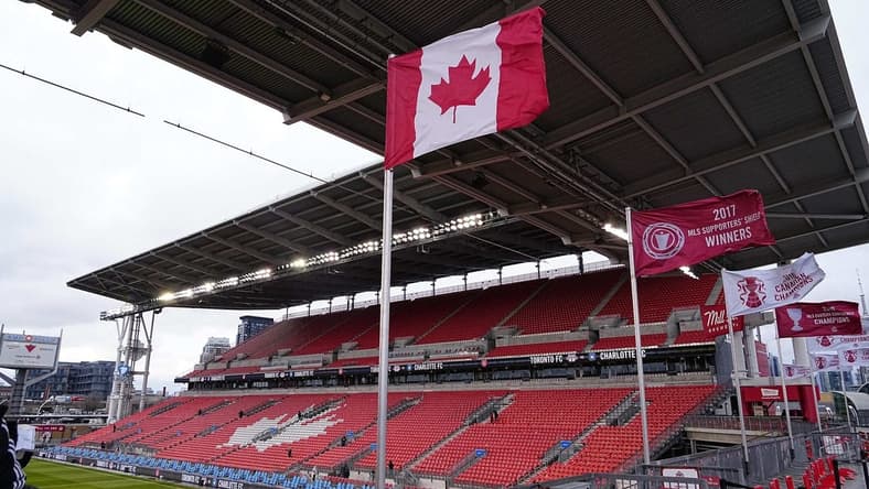 Apr 1, 2023; Toronto, Ontario, CAN; The Canadian flag and championship banners fly in the stiff wind at BMO Field before a match between Charlotte FC and Toronto FC Mandatory Credit: John E. Sokolowski-USA TODAY Sports