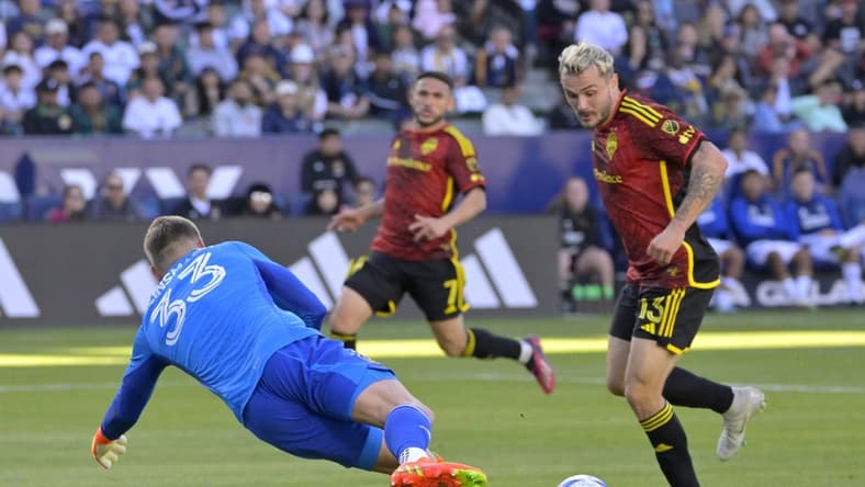 Apr 1, 2023; Carson, California, USA;  Seattle Sounders forward Jordan Morris (13) scores a goal past Los Angeles Galaxy goalkeeper Jonathan Kingsmann (33) in the first half at Dignity Health Sports Park. Mandatory Credit: Jayne Kamin-Oncea-USA TODAY Sports