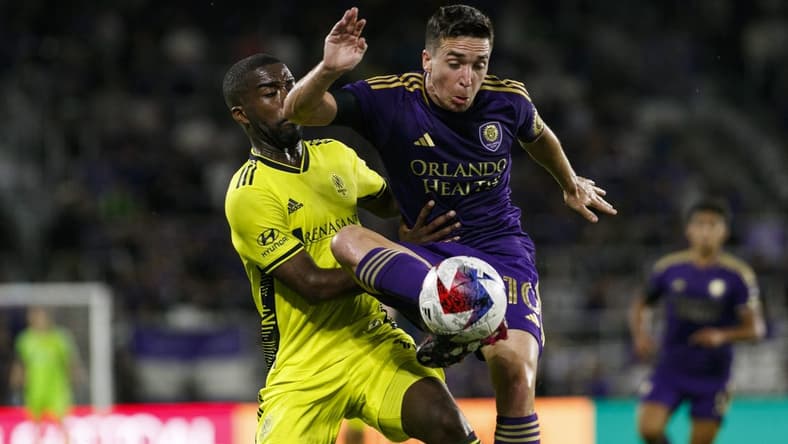 Apr 1, 2023; Orlando, Florida, USA; Orlando City SC midfielder Mauricio Pereyra (10) traps the ball in front of Nashville SC defender Shaq Moore (18) during the first half at Exploria Stadium. Mandatory Credit: Morgan Tencza-USA TODAY Sports