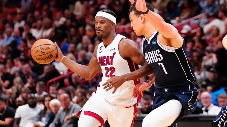 Apr 1, 2023; Miami, Florida, USA; Miami Heat forward Jimmy Butler (22) throws a pass against Dallas Mavericks center Dwight Powell (7) during the second quarter at Miami-Dade Arena. Mandatory Credit: Rich Storry-USA TODAY Sports