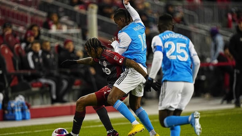 Apr 1, 2023; Toronto, Ontario, CAN; Charlotte FC forward Kerwin Vargas (18) and Toronto FC forward Jahkeele Marshall-Rutty (7) battle for the ball during the first half at BMO Field. Mandatory Credit: John E. Sokolowski-USA TODAY Sports