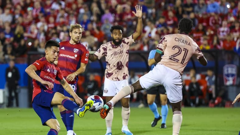 Apr 1, 2023; Frisco, Texas, USA;  FC Dallas forward Alan Velasco (20) and Portland Timbers midfielder Diego Chara (21) go for the ball during the first half at Toyota Stadium. Mandatory Credit: Kevin Jairaj-USA TODAY Sports