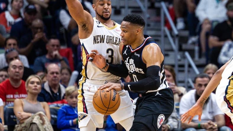 Apr 1, 2023; New Orleans, Louisiana, USA;  LA Clippers guard Russell Westbrook (0) dribbles against New Orleans Pelicans guard CJ McCollum (3) during the first half at Smoothie King Center. Mandatory Credit: Stephen Lew-USA TODAY Sports