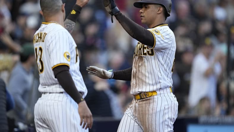 Apr 1, 2023; San Diego, California, USA; San Diego Padres left fielder Juan Soto (right) greets third baseman Manny Machado (left) after scoring on the double by first baseman Matt Carpenter (not pictured) against the Colorado Rockies during the third inning at Petco Park. Mandatory Credit: Ray Acevedo-USA TODAY Sports
