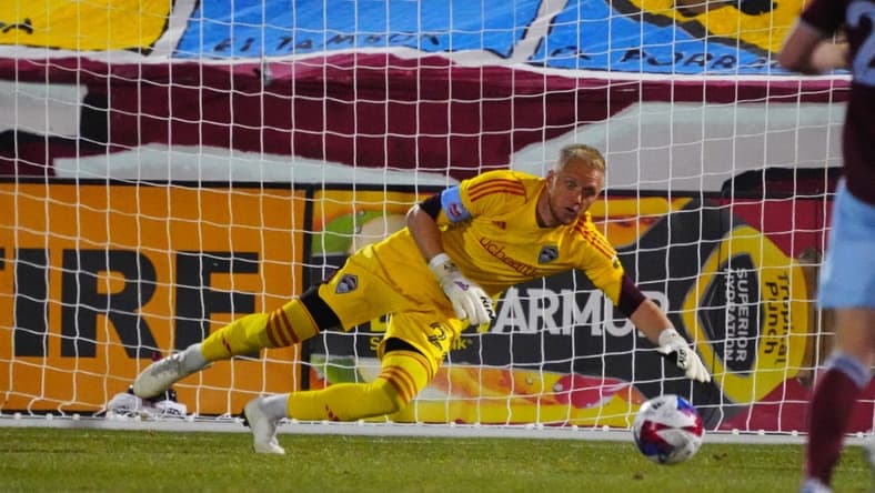 Apr 1, 2023; Commerce City, Colorado, USA; Colorado Rapids goalkeeper William Yarbrough (22) reaches for the ball during the first half at Dick's Sporting Goods Park. Mandatory Credit: Ron Chenoy-USA TODAY Sports