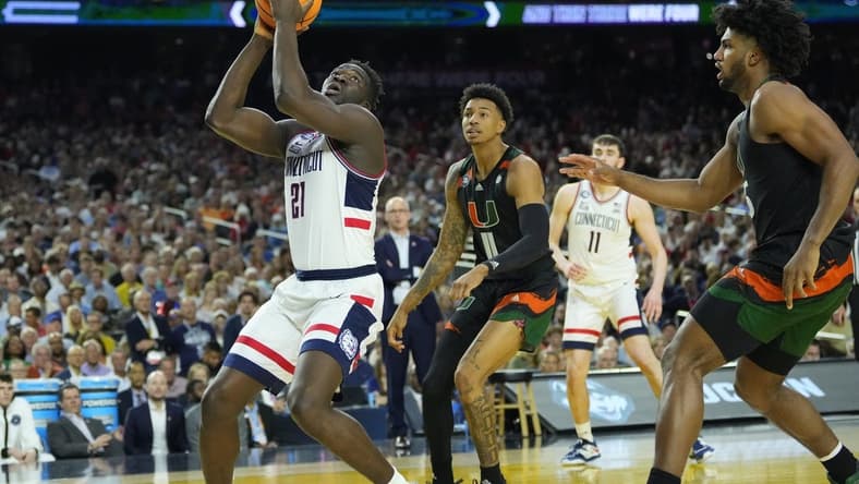 Apr 1, 2023; Houston, TX, USA; Connecticut Huskies forward Adama Sanogo (21) shoots against the Miami Hurricanes in the semifinals of the Final Four of the 2023 NCAA Tournament at NRG Stadium. Mandatory Credit: Robert Deutsch-USA TODAY Sports