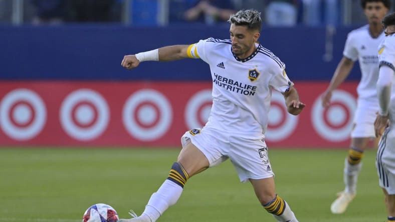 Apr 1, 2023; Carson, California, USA; Los Angeles Galaxy midfielder Gaston Brugman (5) handles the ball during the game against the Seattle Sounders at Dignity Health Sports Park. Mandatory Credit: Jayne Kamin-Oncea-USA TODAY Sports
