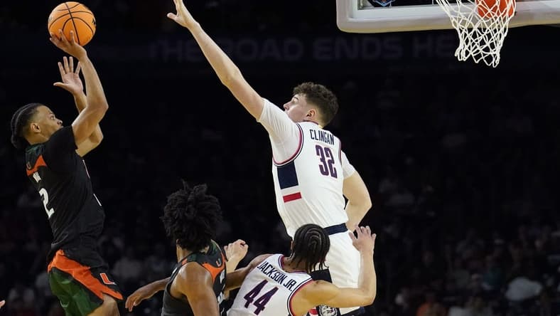 Apr 1, 2023; Houston, TX, USA; Miami (Fl) Hurricanes guard Isaiah Wong (2) shoots the ball as Connecticut Huskies center Donovan Clingan (32) defends during the second half in the semifinals of the Final Four of the 2023 NCAA Tournament at NRG Stadium. Mandatory Credit: Bob Donnan-USA TODAY Sports