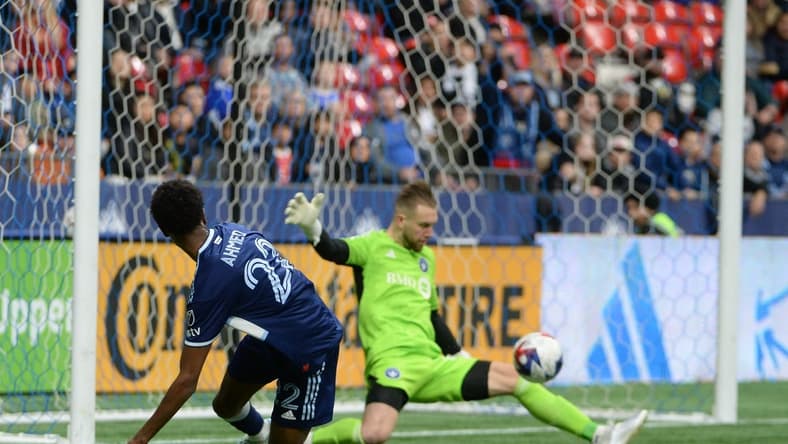 Apr 1, 2023; Vancouver, British Columbia, CAN; CF Montreal goalkeeper Jonathan Sirois (40) makes a save against Vancouver Whitecaps forward Ali Ahmed (22) during the first half at BC Place. Mandatory Credit: Anne-Marie Sorvin-USA TODAY Sports