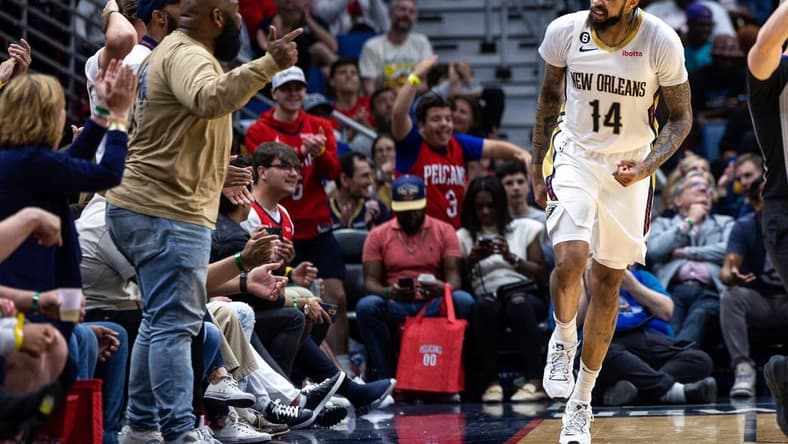 Apr 1, 2023; New Orleans, Louisiana, USA;  New Orleans Pelicans forward Brandon Ingram (14) reacts to making a basket against LA Clippers forward Kawhi Leonard (2) with a fan during the second half at Smoothie King Center. Mandatory Credit: Stephen Lew-USA TODAY Sports